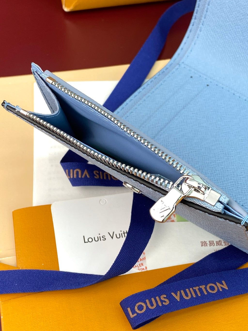 Light blue Louis Vuitton small bag with zipper pocket and silver-tone hardware