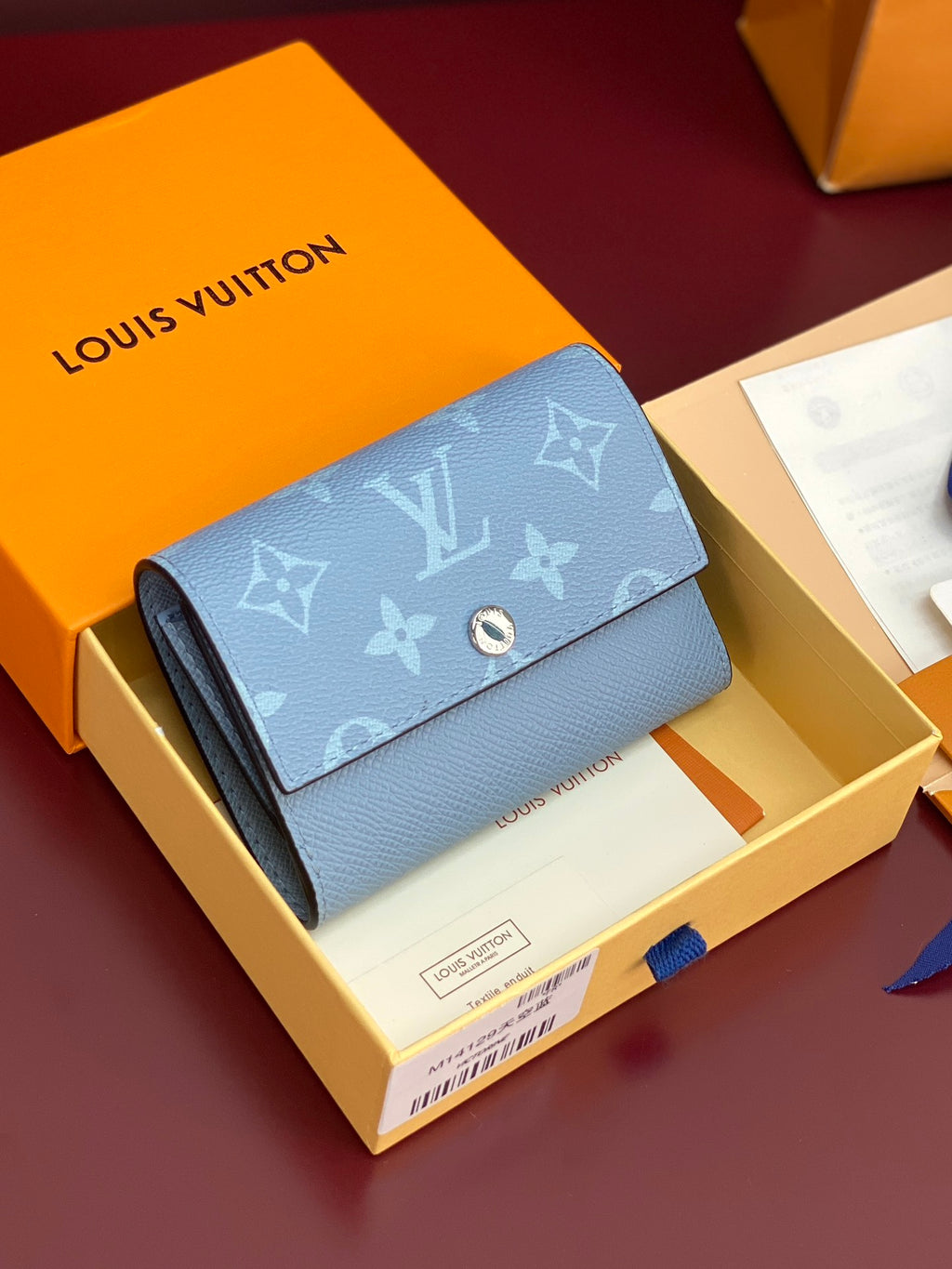Light blue Louis Vuitton small bag with monogram flap and gold snap closure