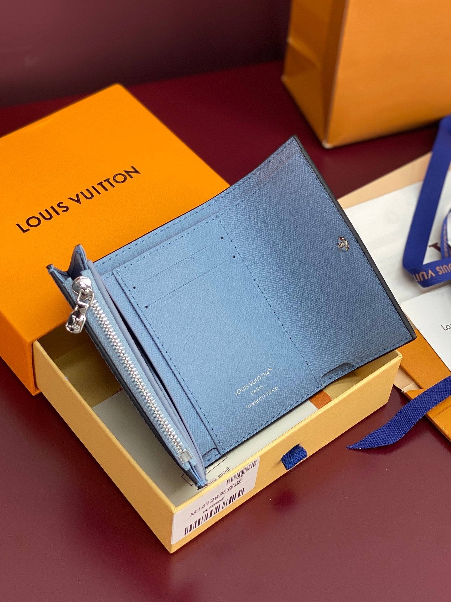Light blue Louis Vuitton small bag with side zip opening and flap front