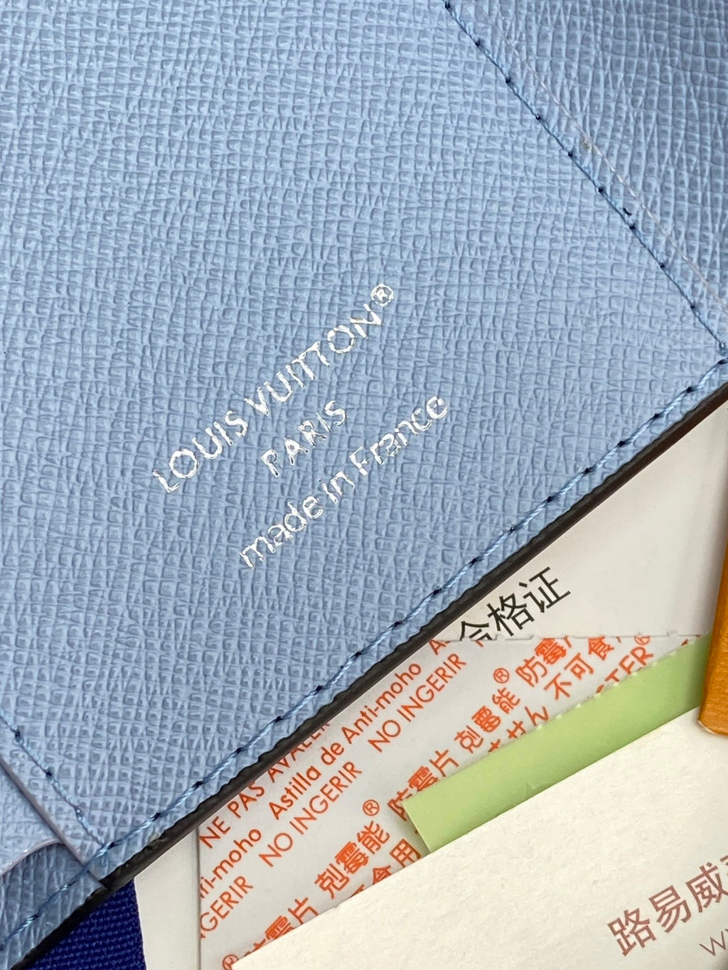 Light blue Louis Vuitton small bag with textured leather and stitched interior edge