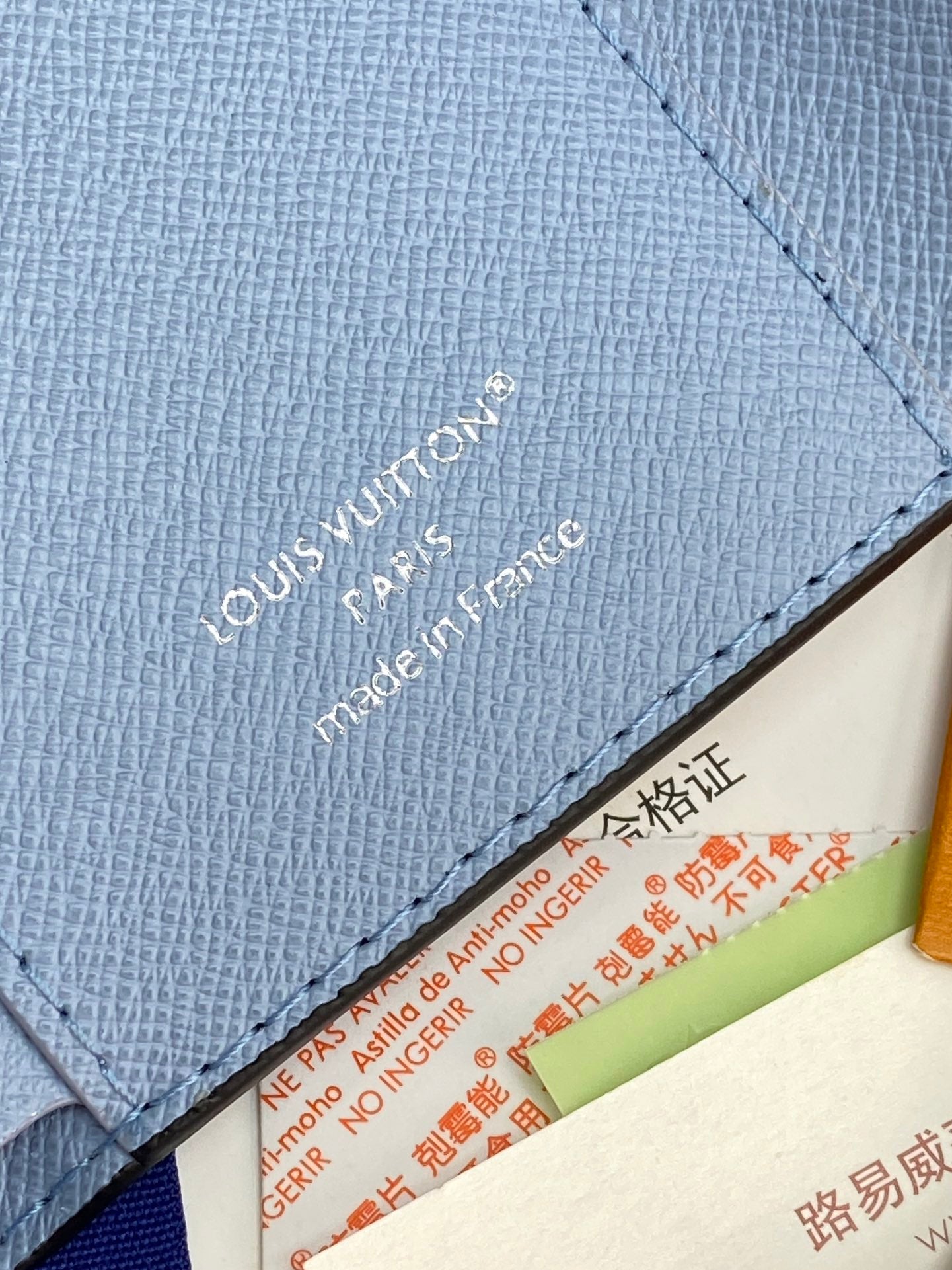 Light blue Louis Vuitton small bag with textured leather and stitched interior edge