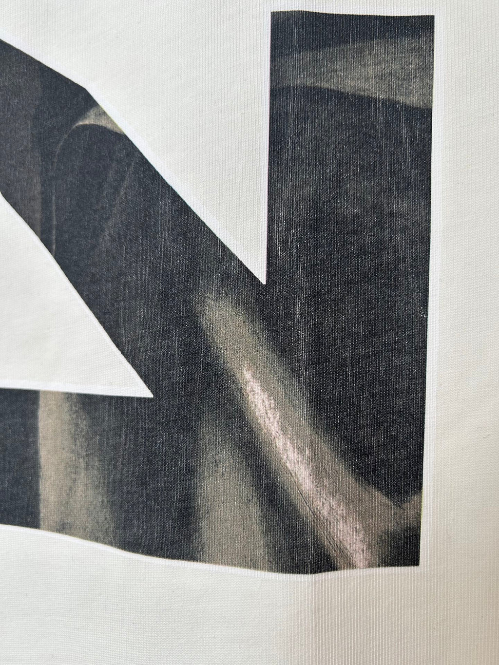Off-White T-shirt close-up of back graphic photo panel in dark tones