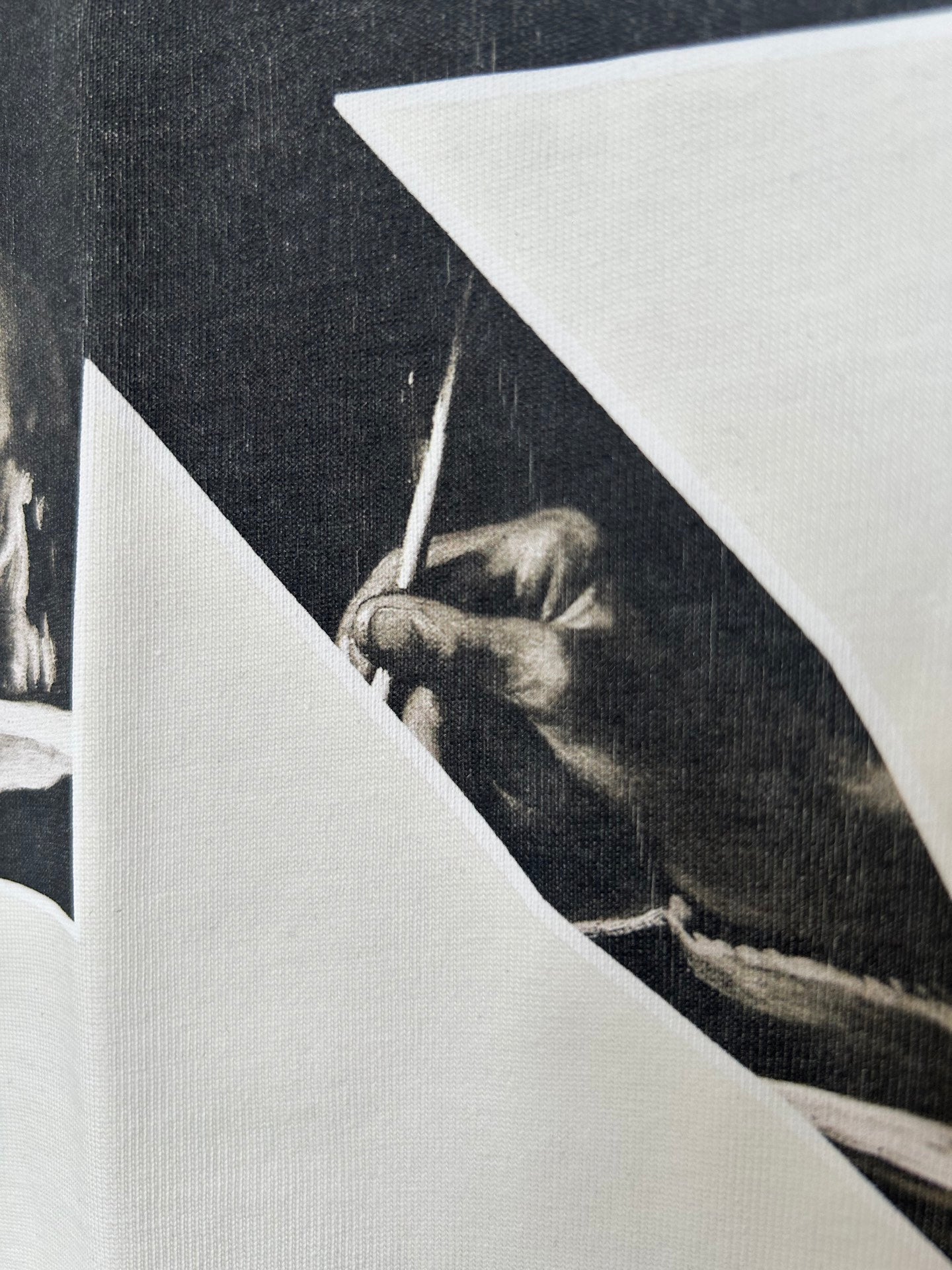 Off-White T-shirt close-up of back graphic photo panel with hand and tool