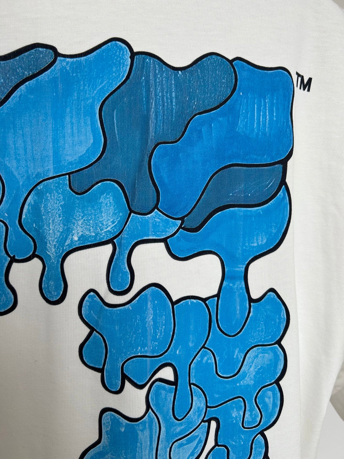 Off-white T-shirt with close-up blue printed graphic texture