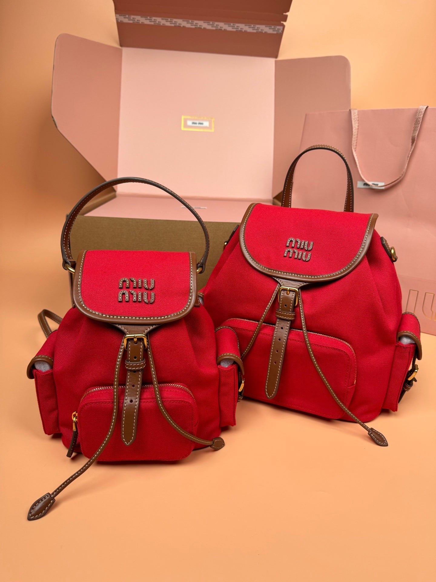 MiuMiu small flap backpacks, red and olive green with top handles and adjustable straps
