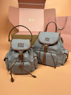 MiuMiu small flap backpacks, gray and sage green with top handles and adjustable straps