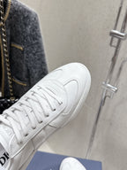 White Dior unisex sneaker close-up, lace detail and side logo