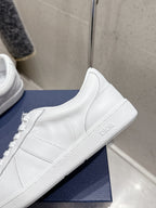 White Dior unisex sneaker on blue box, side panel and stitched trim