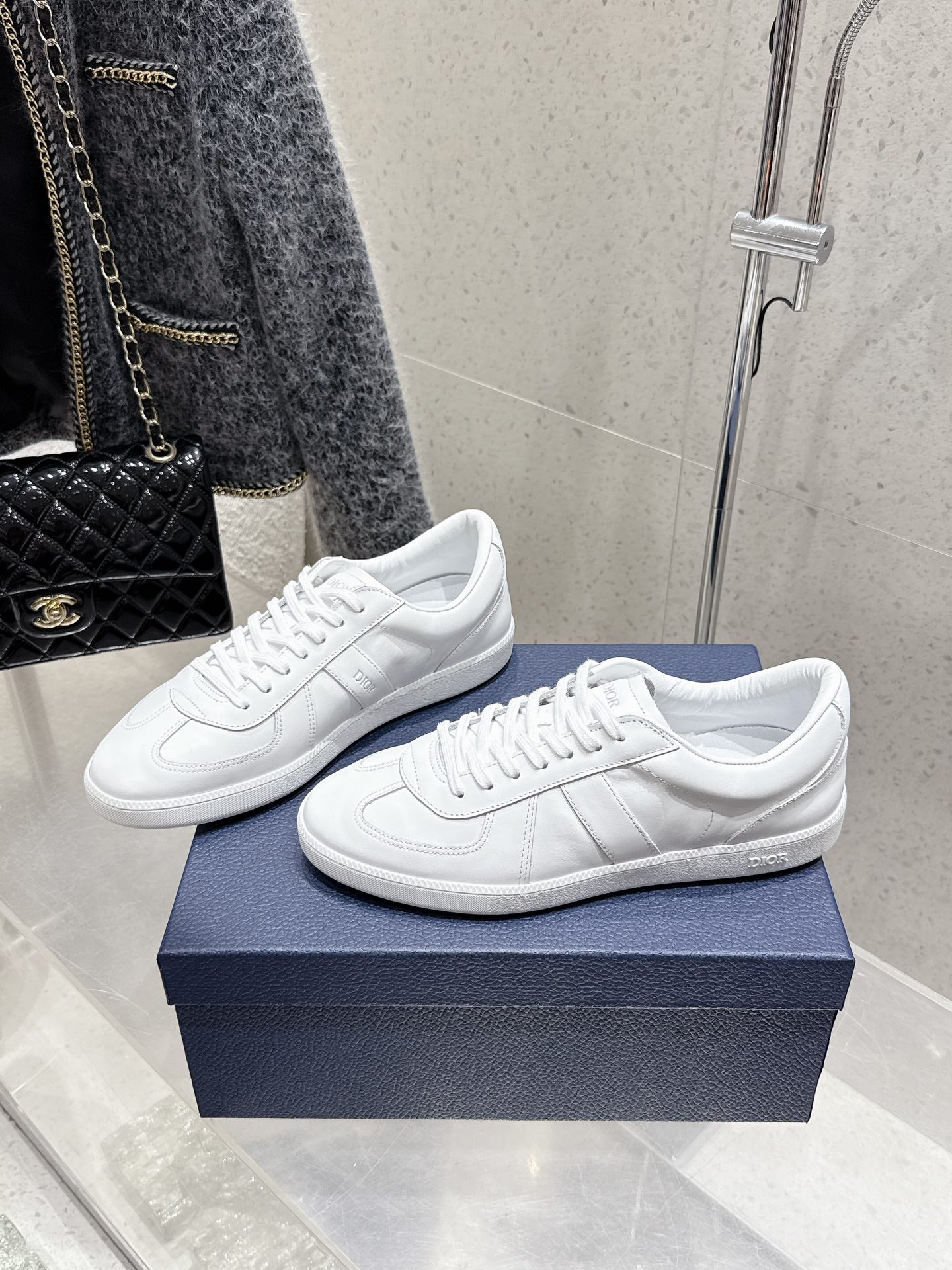 White Dior unisex sneakers, side view pair with lace-up and low profile