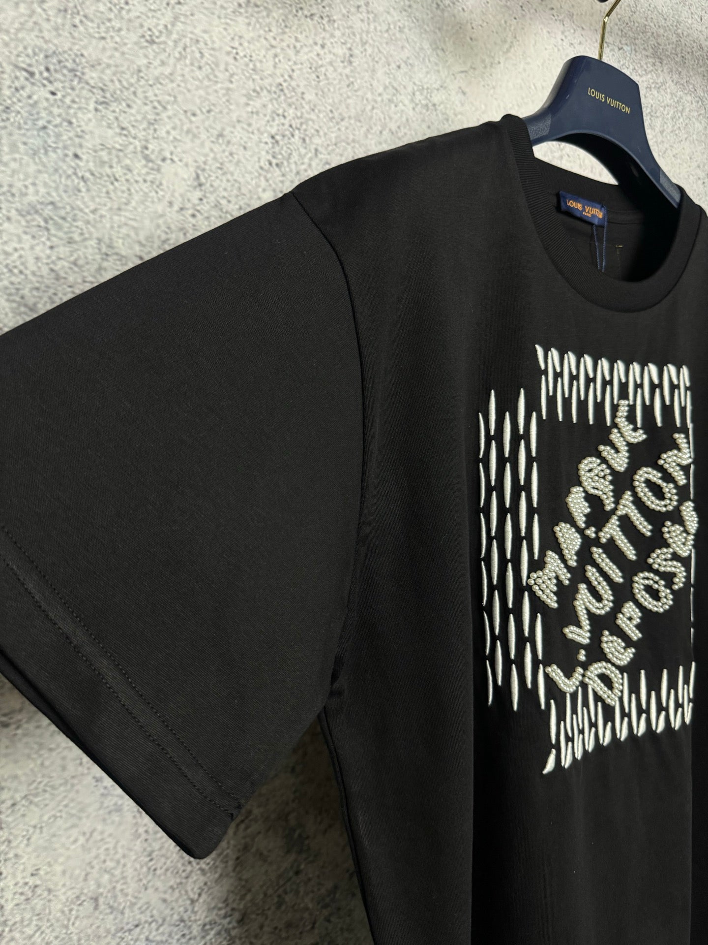 Louis Vuitton black short-sleeve T-shirt with rhinestone chest graphic, angled view