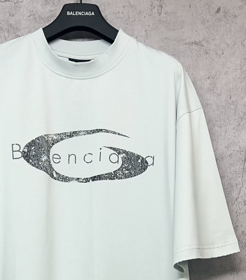 Balenciaga short-sleeve T-shirt in light mint with oval graphic logo print, angled view
