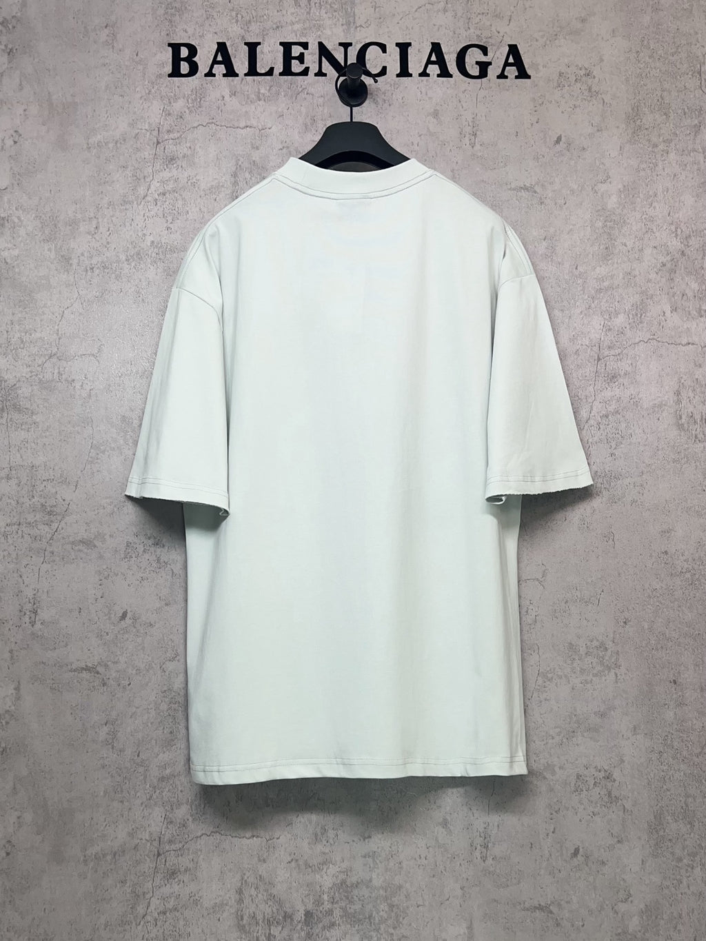 Balenciaga short-sleeve T-shirt in light mint, back view on hanger