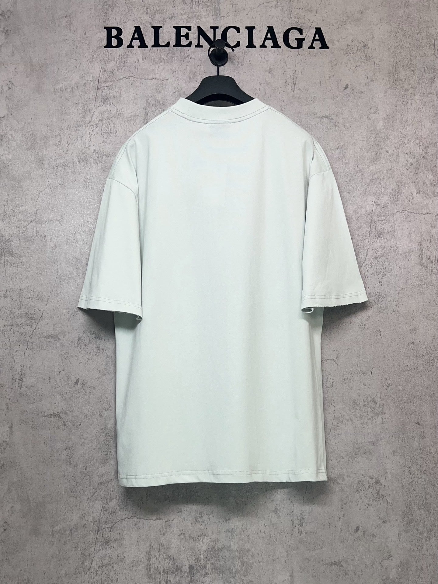 Balenciaga short-sleeve T-shirt in light mint, back view on hanger