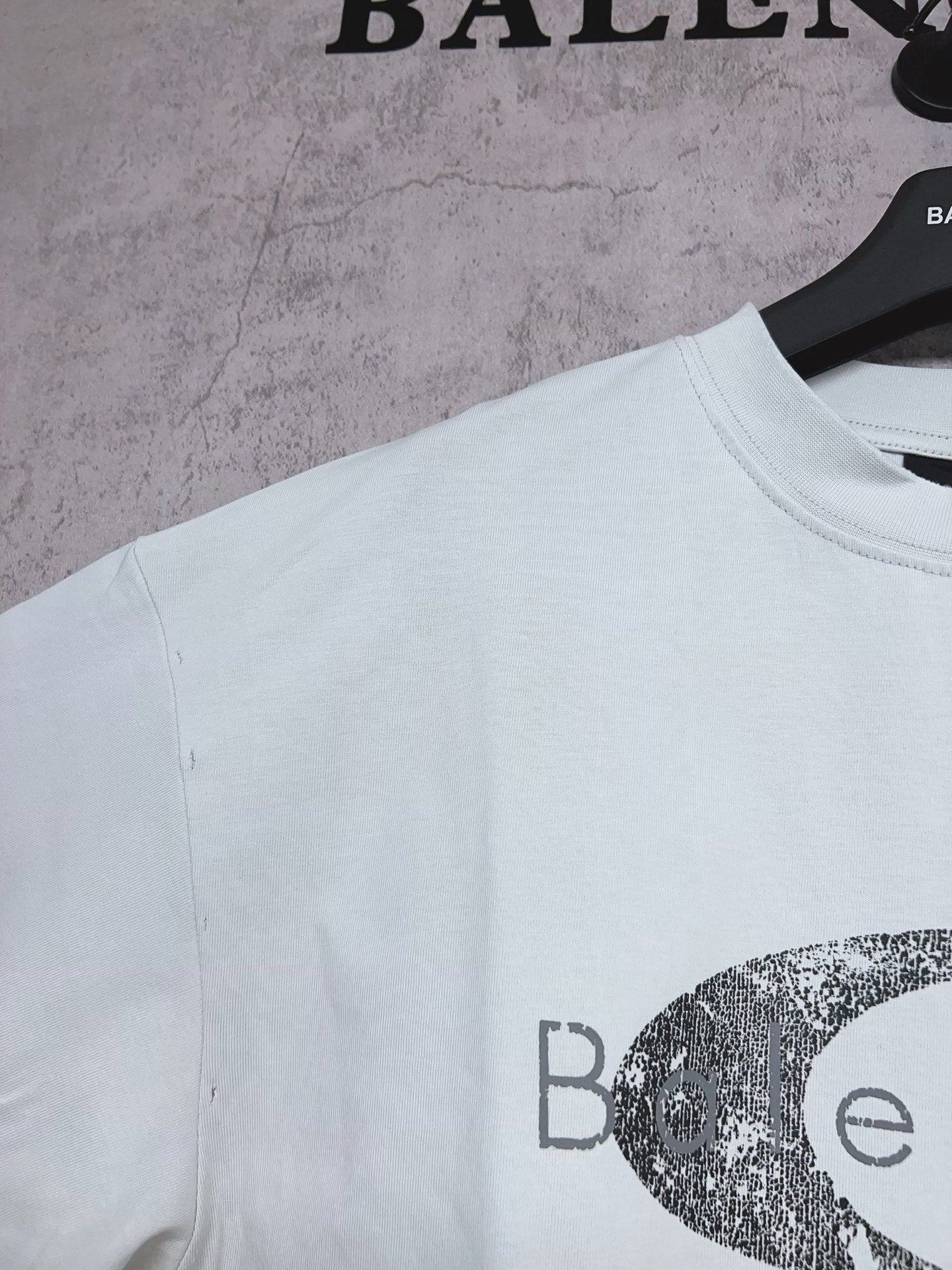 Balenciaga short-sleeve T-shirt in light mint with partial oval graphic logo print, side angle