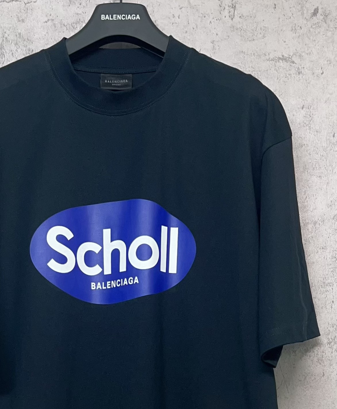 Balenciaga short-sleeve T-shirt, dark navy, close-up of front “Scholl” oval logo