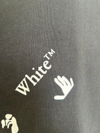 Black T-shirt sleeve close-up with White TM text and hand logo