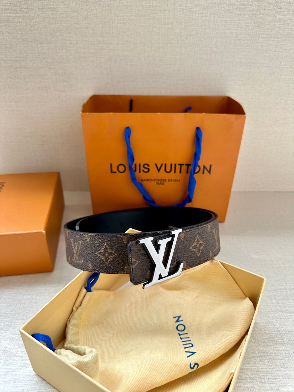 Louis Vuitton monogram belt with gold buckle, dark brown leather strap