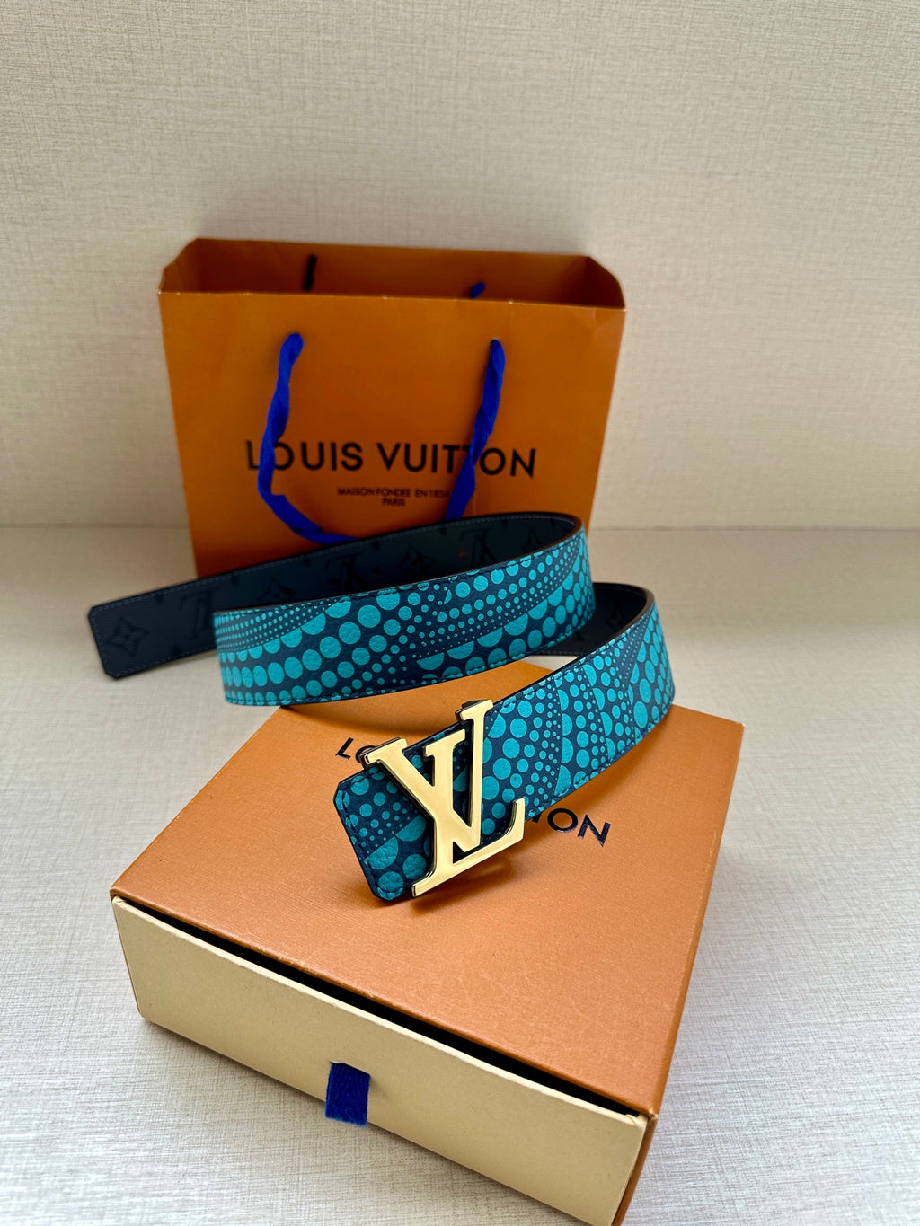 Louis Vuitton belt turquoise dotted strap with gold LV buckle on the box top