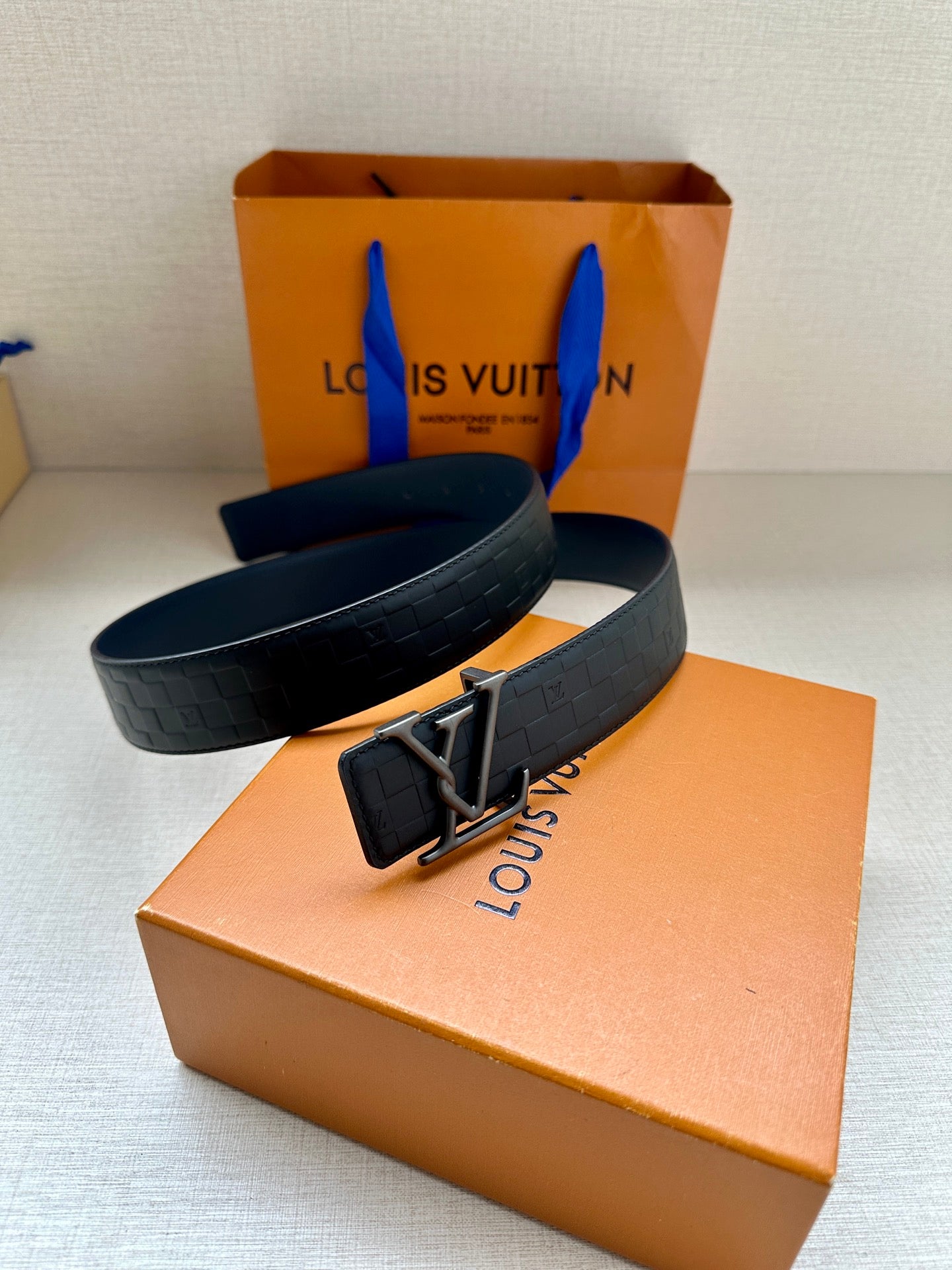 Dark navy belt with LV buckle and quilted embossed strap