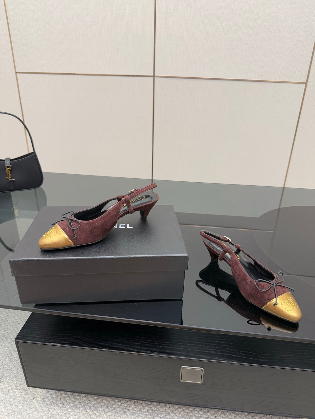 Women’s low-heel flats in burgundy suede and gold toe cap, red lace-up ties.