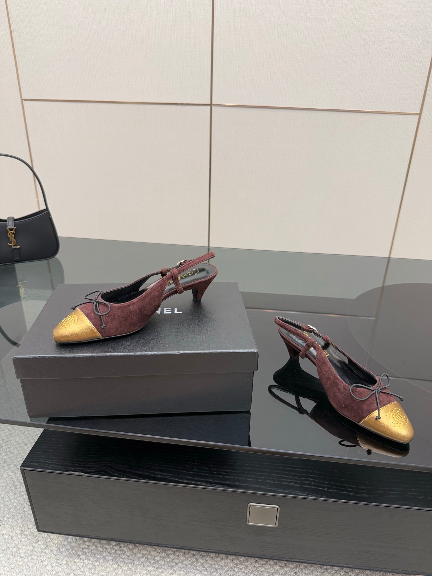 Women’s low-heel flats in burgundy suede and gold toe cap, red lace-up ties.