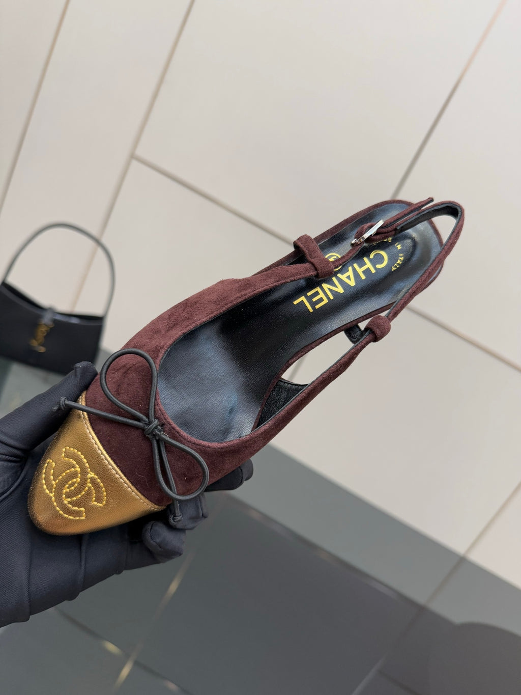 Women’s flats top view, burgundy suede with gold toe panel and red laces, CHANEL lining.