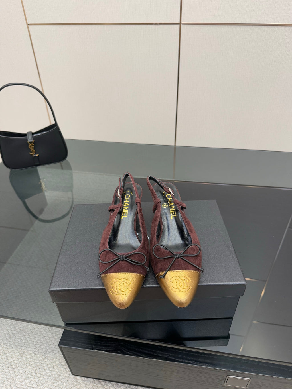 Two-tone women’s ballet flats with low heel, burgundy suede and gold toe, lace ties.