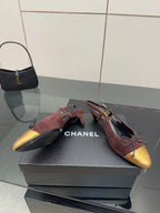 Women’s pointed-toe flats with burgundy suede and gold toe cap, red laces, CHANEL lining.