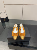 Tan suede slingback flats with lace-up bow and gold embossed toe detail, kitten heel