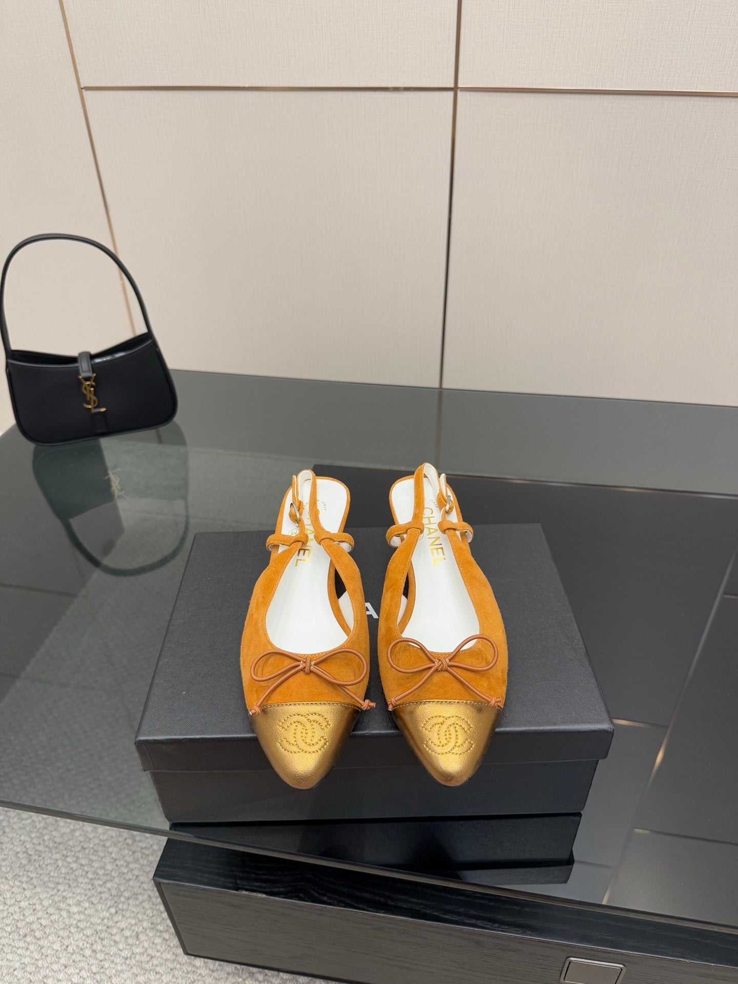 Tan suede slingback flats with lace-up bow and gold embossed toe detail, kitten heel