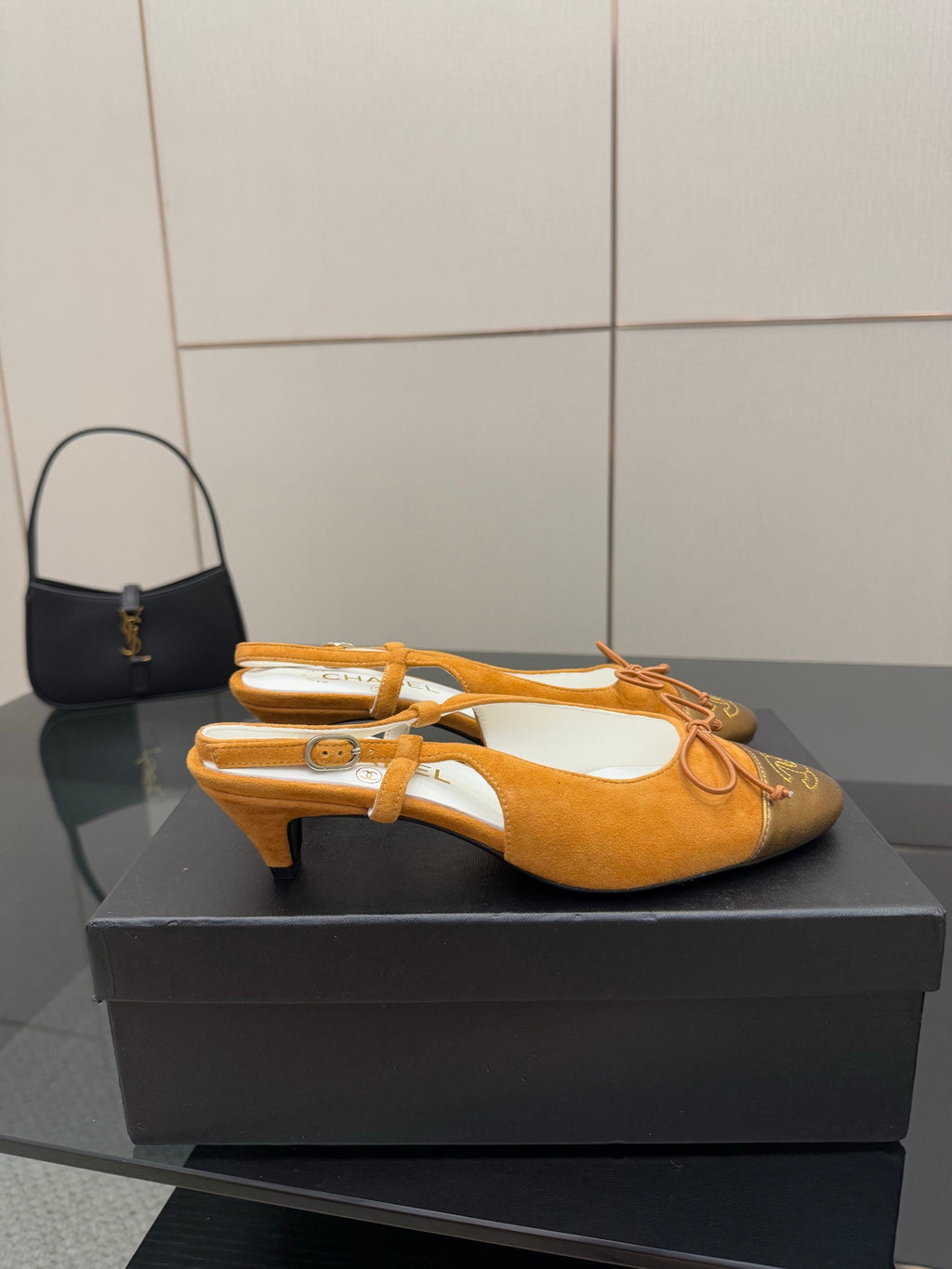 Tan suede slingback flats with lace-up bow and gold heel trim, kitten heel