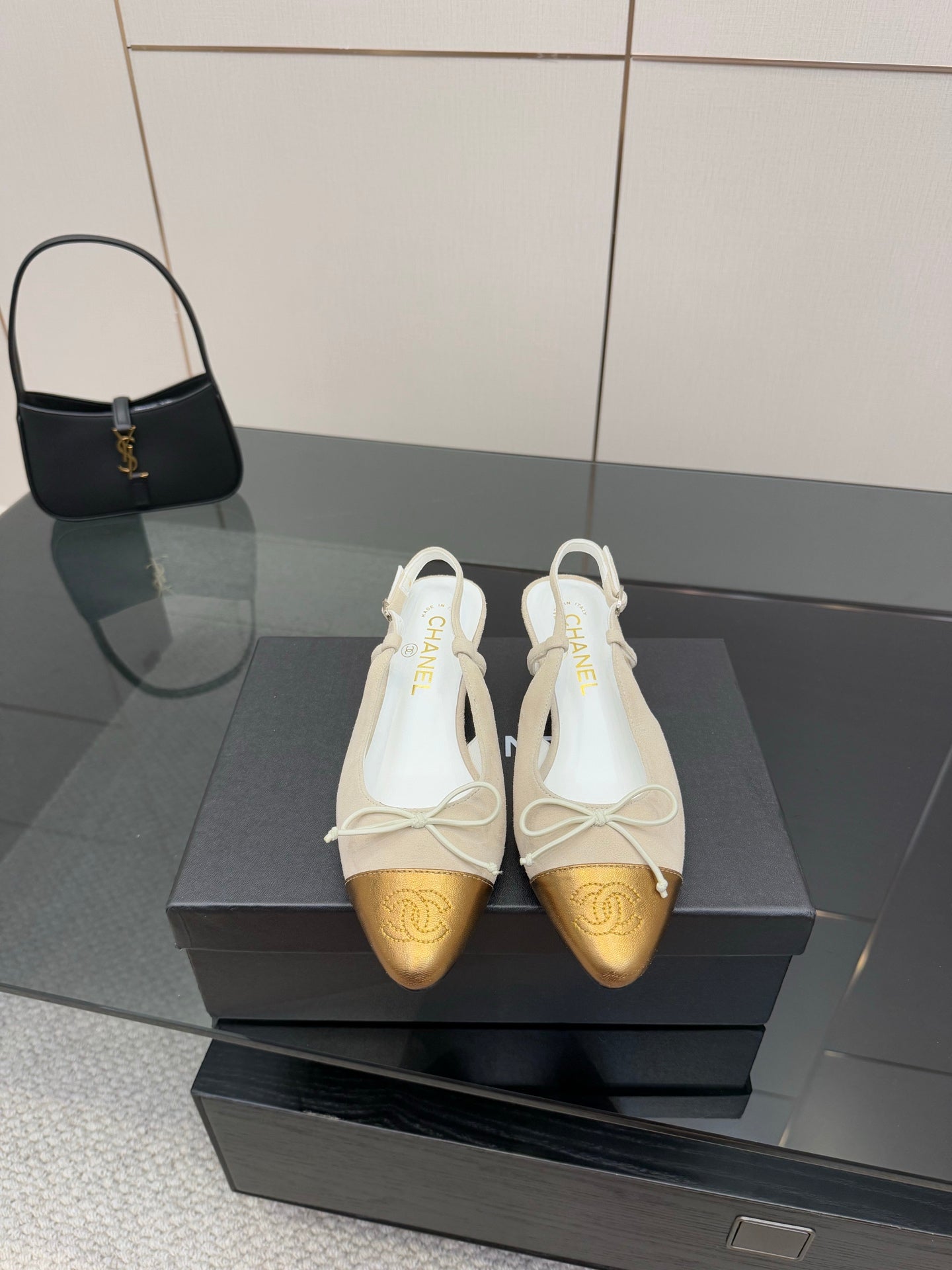 Women’s slingback heels with white uppers, gold toe cap, and lace bow detail