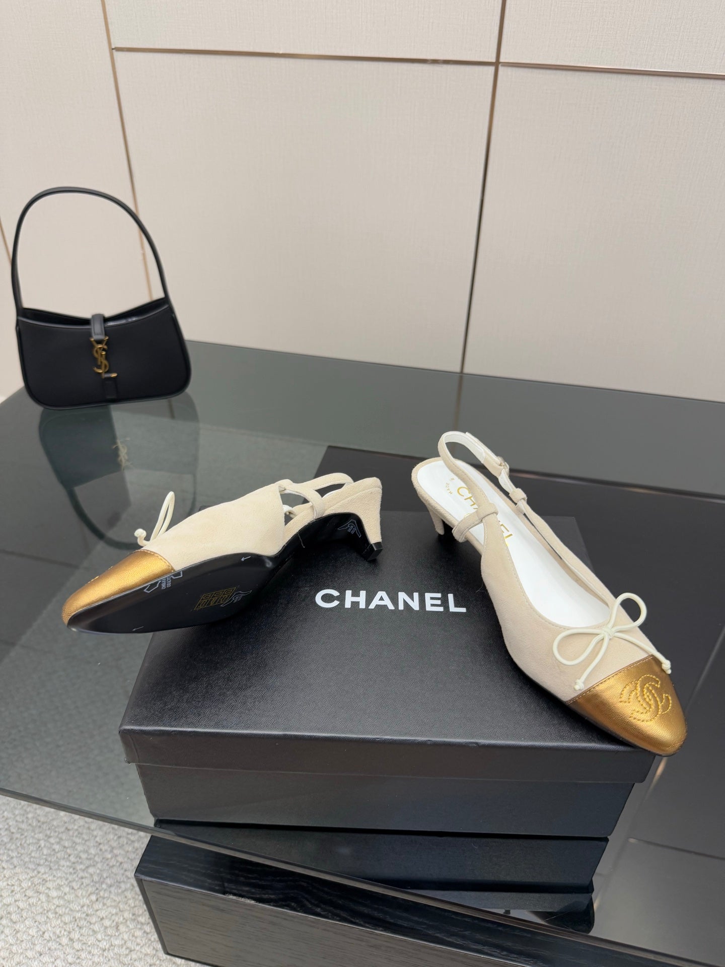 Women’s slingback heels with white uppers, gold toe caps, and lace bow ties
