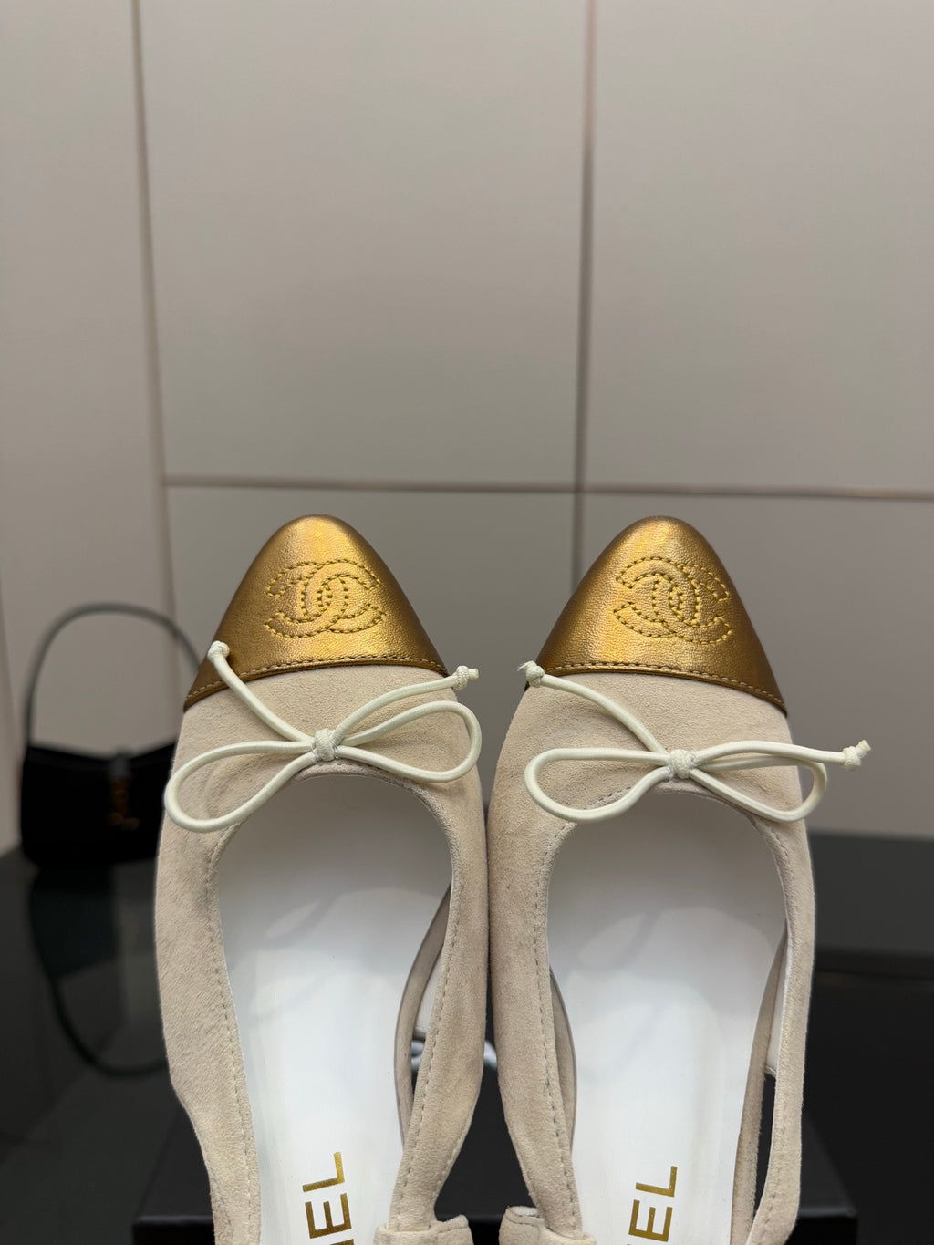 Women’s slingback heels close-up, gold toe cap, white laces, low block heel