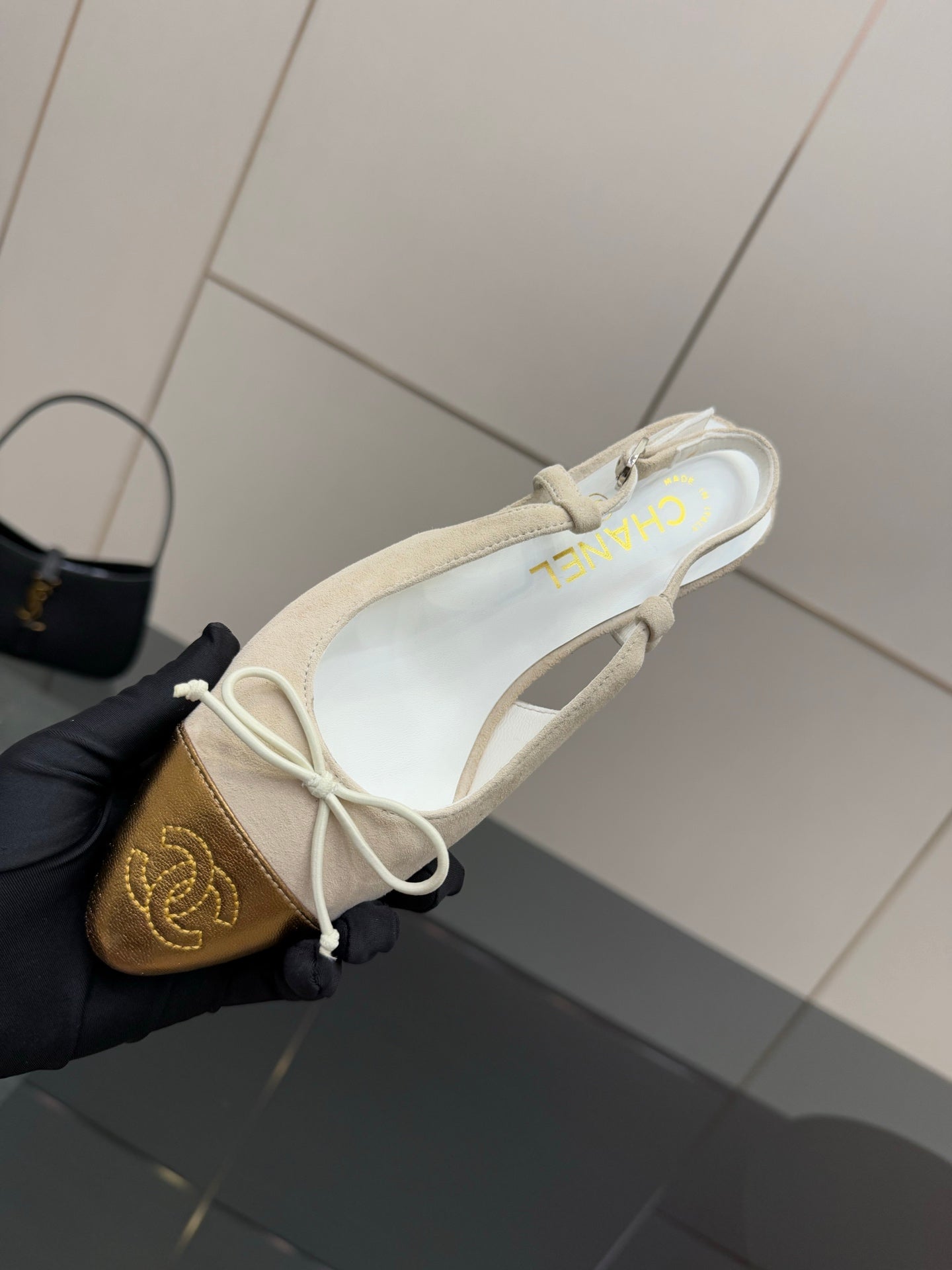 Women’s slingback heel top view, white straps, gold toe cap, lace bow detail