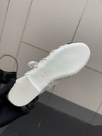 White sneaker outsole with circular logo stamp on heel