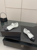 White lattice lace-up sneakers with black toe and gold emblem, side view