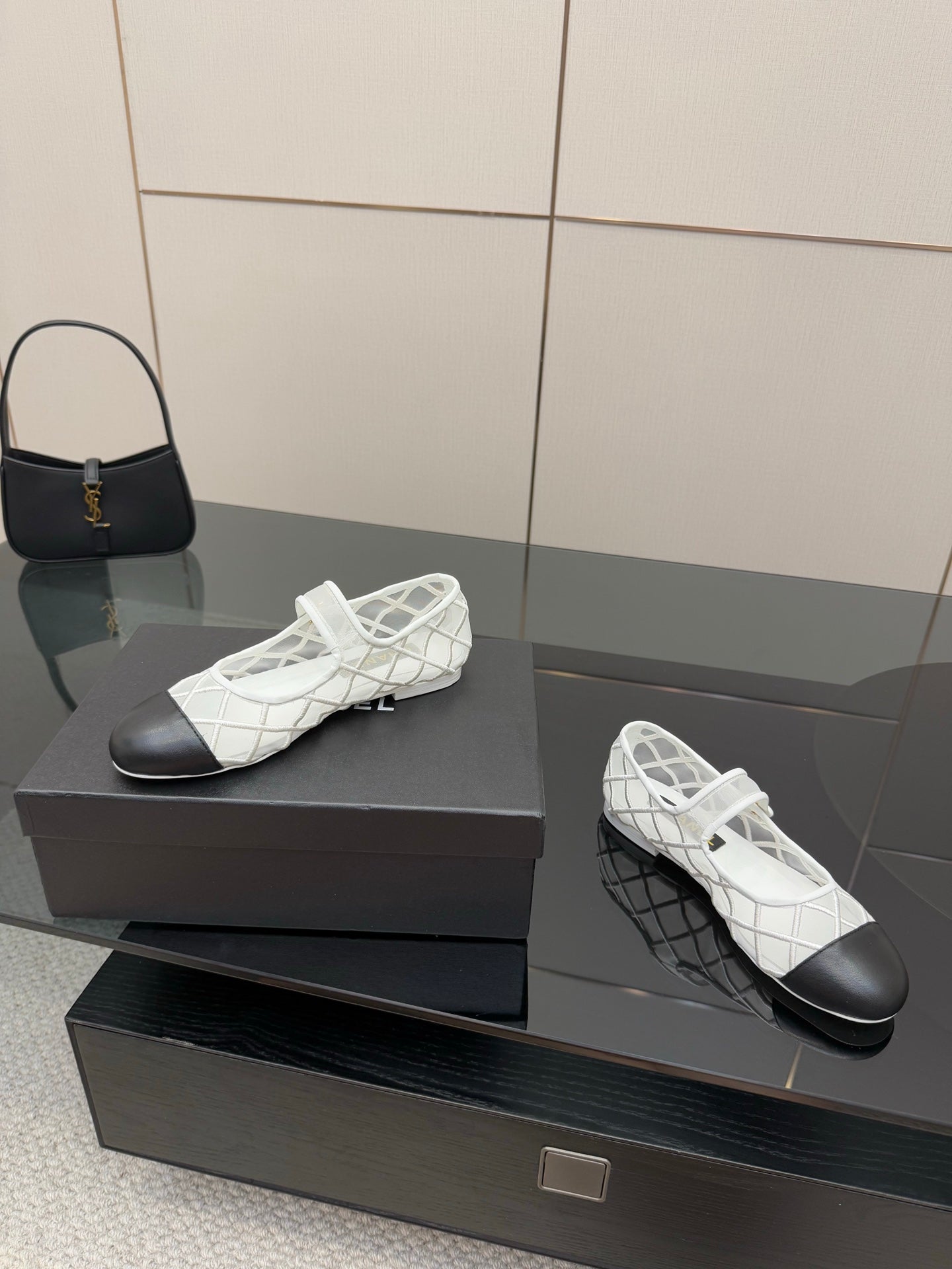 White lattice lace-up sneakers with black toe and gold emblem, side view
