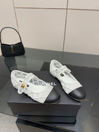 White lattice lace-up sneakers, black toe caps and gold Chanel emblem