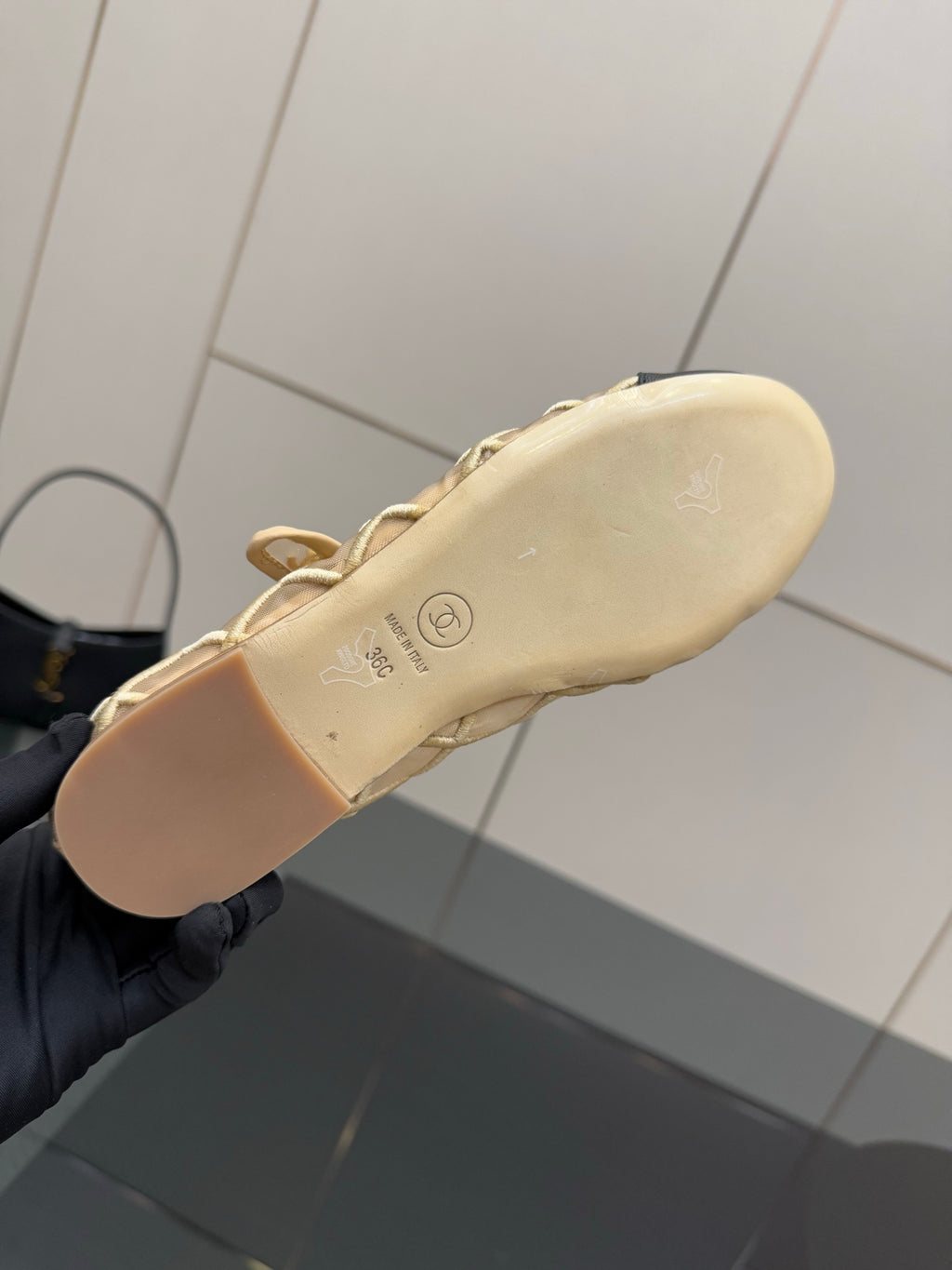 Chanel ladies flat outsole in beige, shown from underside in hand