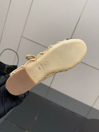 Chanel ladies flat outsole in beige, shown from underside in hand