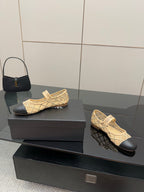 Chanel ladies beige flats with black outsoles shown side-by-side on box