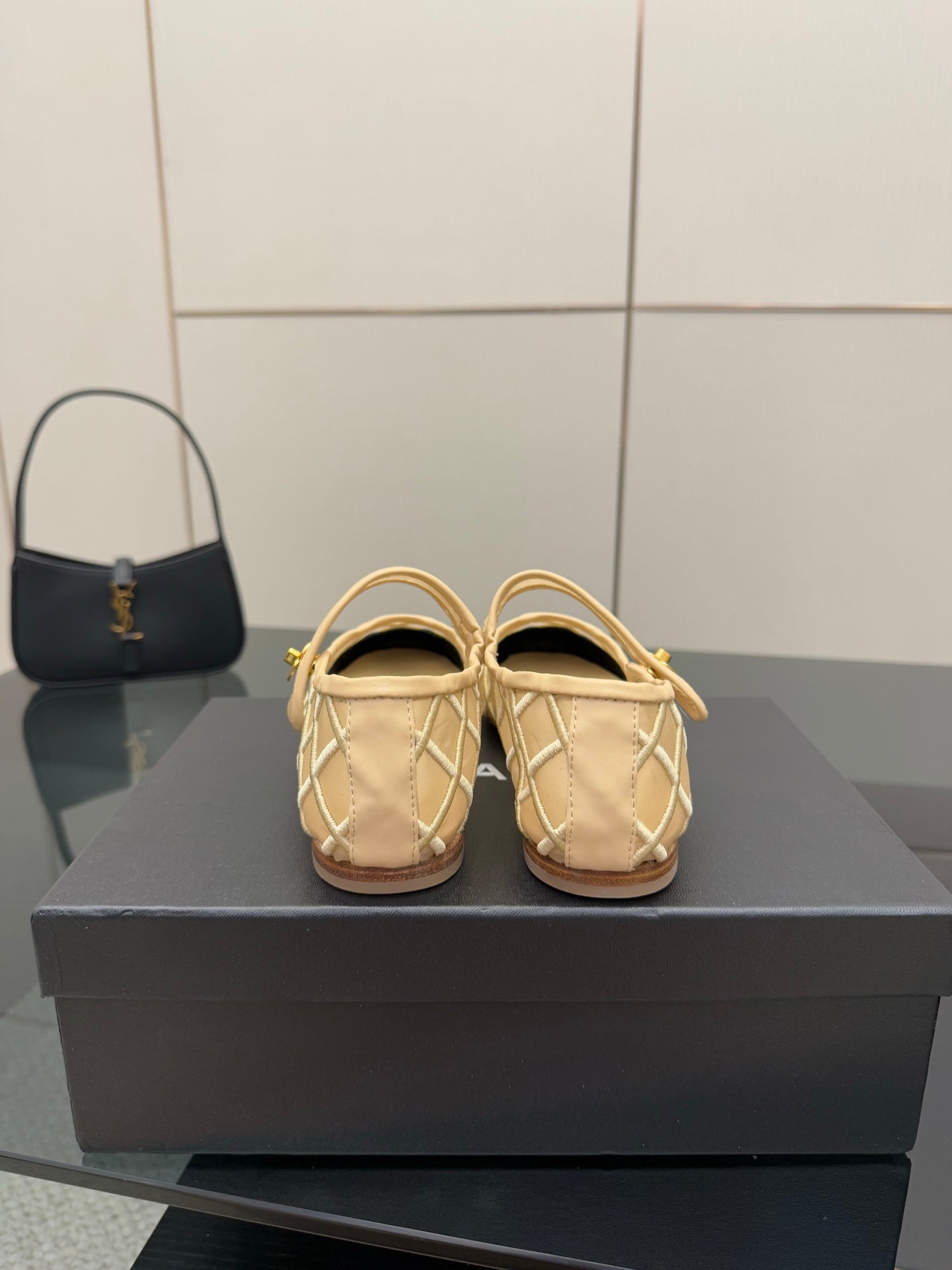 Chanel ladies beige flats with gold emblem and black heel accents
