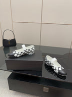 Women's slip-on flats with open collar, white and black grid pattern and gold charm