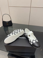 Women's slip-on flats, white leather with black lattice trim, featuring CHANEL logo