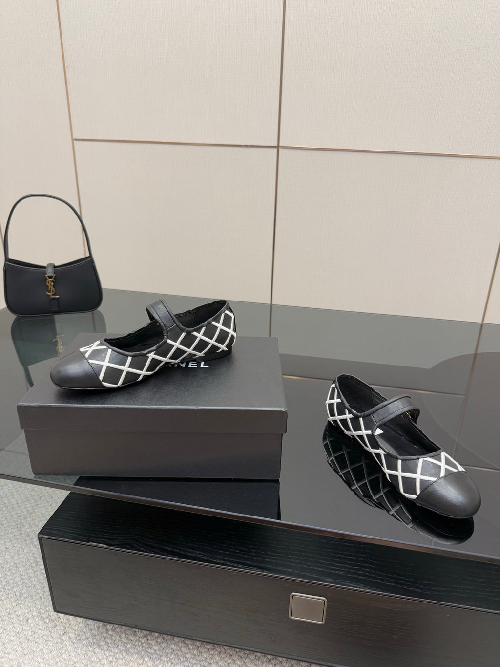 Black Chanel slip-on flats with white lattice upper and black strap