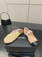 Pink lattice flats with black toe and beige sole underside