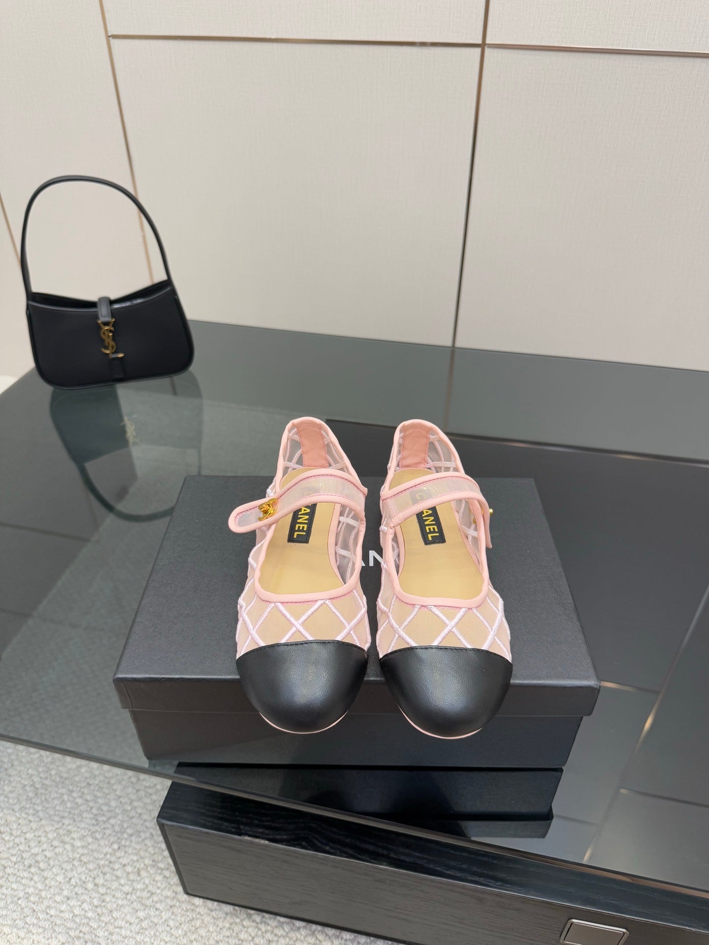 Pink slingback flats with white lattice straps and black toe caps