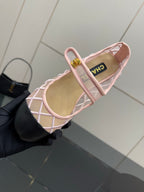 Pink lattice flats with gold logo clasp and green-lined insole