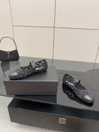 Chanel women’s black quilted flats with crisscross straps, angled pair on box
